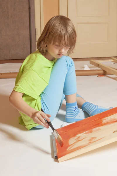 Boy with Blond Hair Painting a Board