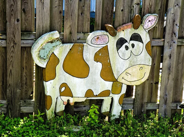 Funny Wooden Cow on Fence