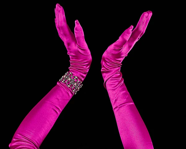 Arms Extended wearing Fuchsia long sleeve Gloves isolated on Black