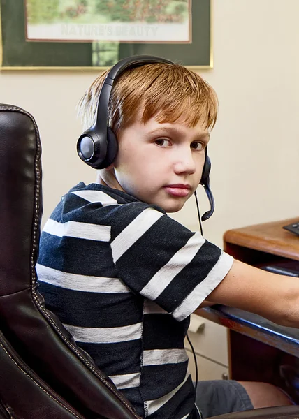 Boy Wearing Headset while Playing Video Games