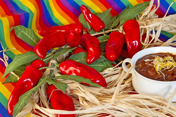 Mexican  Bowl of Chili surrounded by peppers