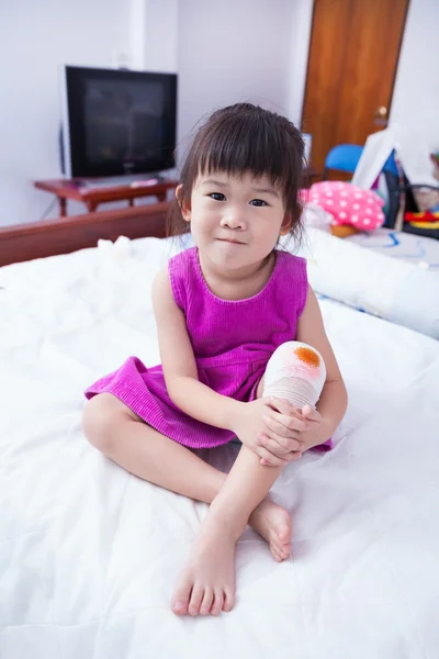 Full body. Child injured. Wound on the child\'s knee with bandage