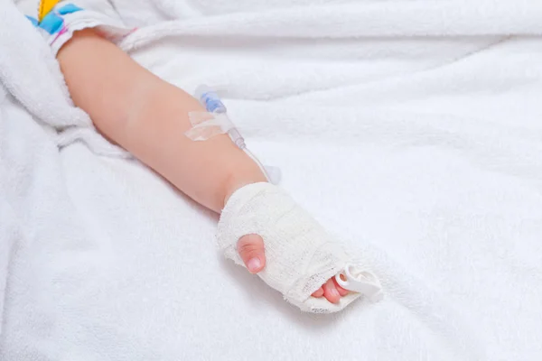 Closeup of a patient hand with disposable infusion