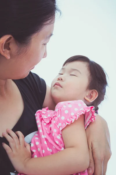 Sleepy little asian child with mom, happy family concept. Mother