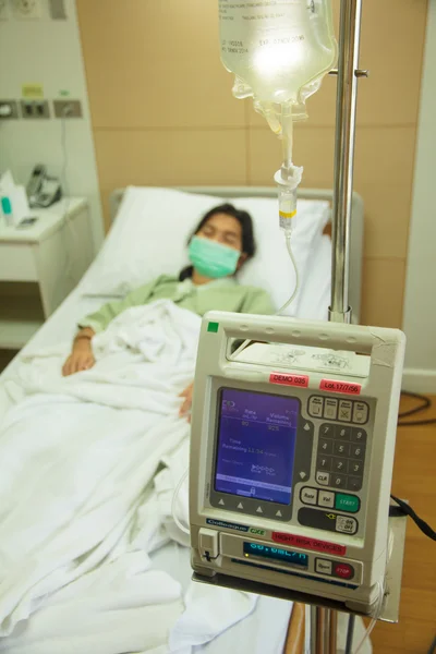 Intravenous IV Drip Pump In a Hospital Room with Patient - Stock