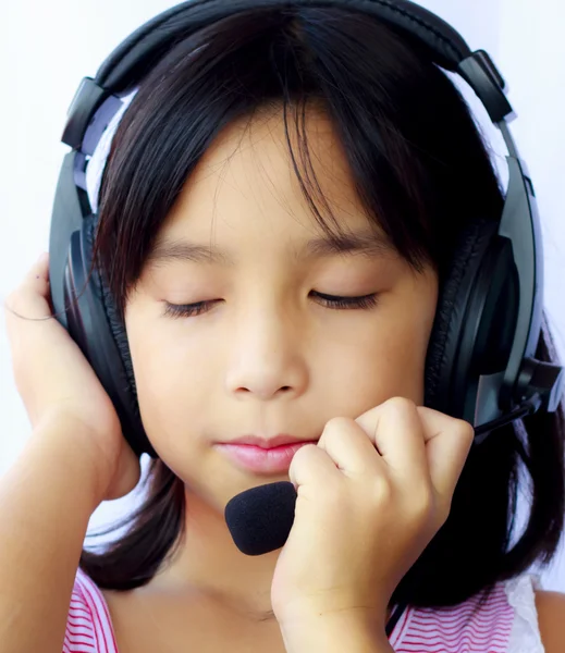 Asia girl wearing headphones on white background