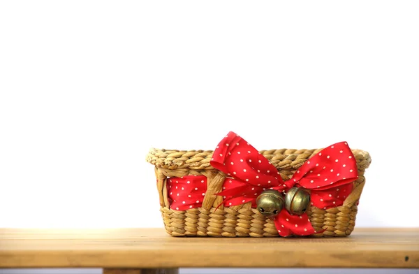 Stock Photo Basket caught red ribbon on wooden table