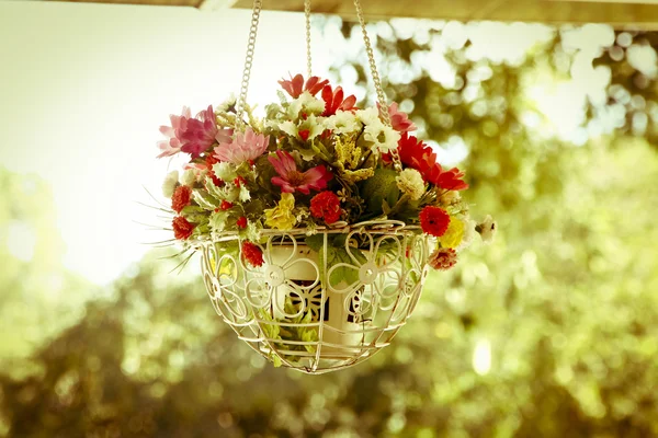 Beautiful flower hanging basket in the garden- vintage effect fi