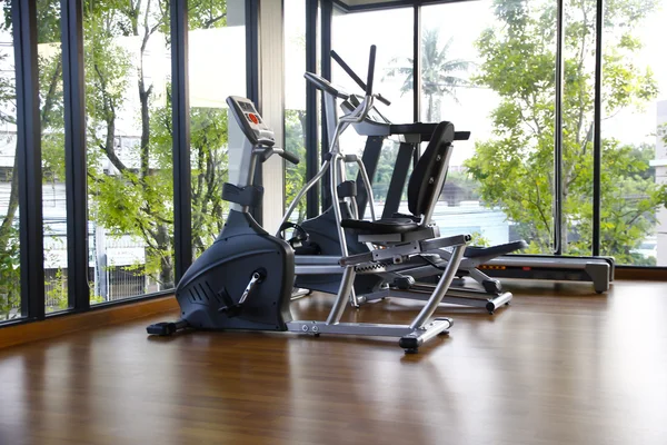 Stock Photo Gym with windows and running machines with wooden floor