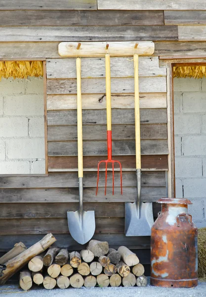 Stock Photo: image of garden tools hanging on side walls wooden.