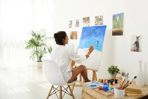 Mid adult woman painting
