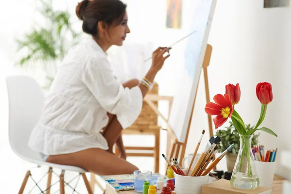 Artist studio  with woman painting