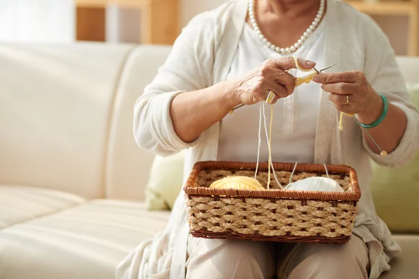 Grandmother knitting at home