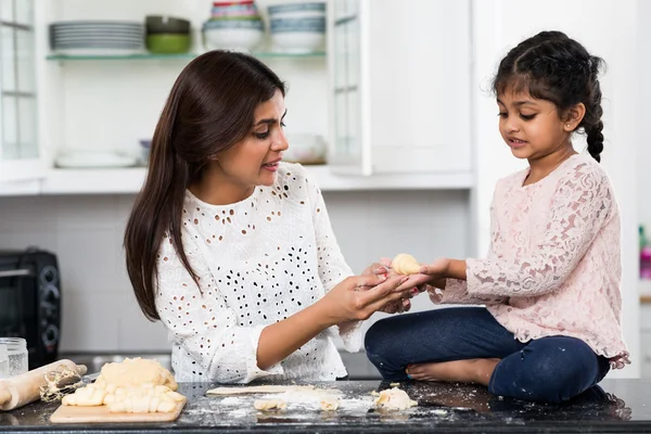 Girl showing croissant to her mother