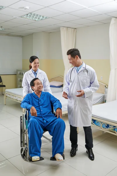 Doctor talking to disabled man