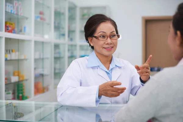 Pharmacist talking to customer