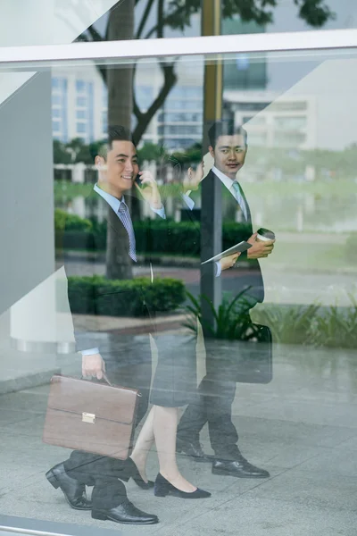 Entrepreneurs walking inside office building