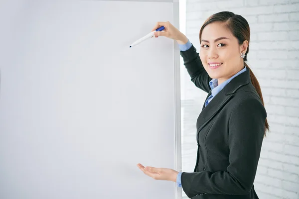 Business lady explaining ideas on whiteboard