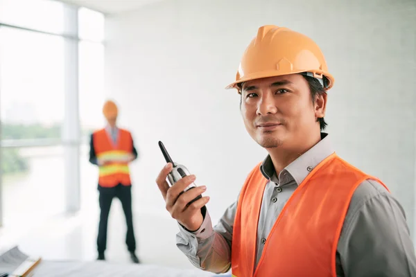Contractor with walkie-talkie in hands