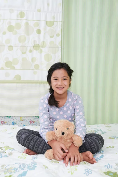 Girl sitting on bed