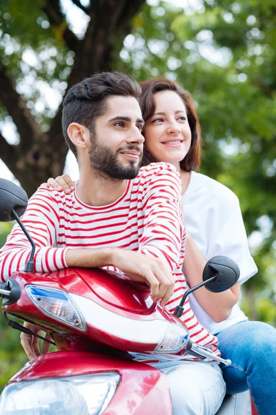 Hispanic couple on scooter
