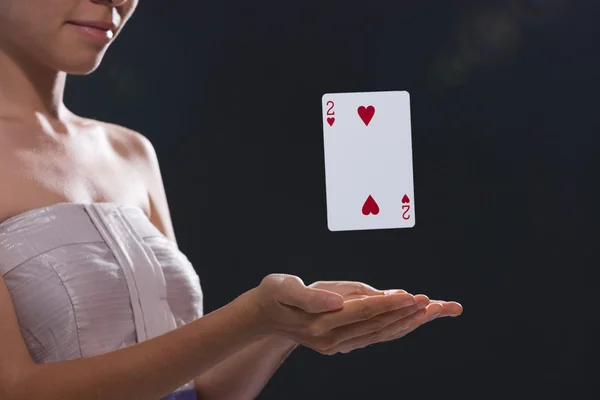 Woman using magic to make playing card