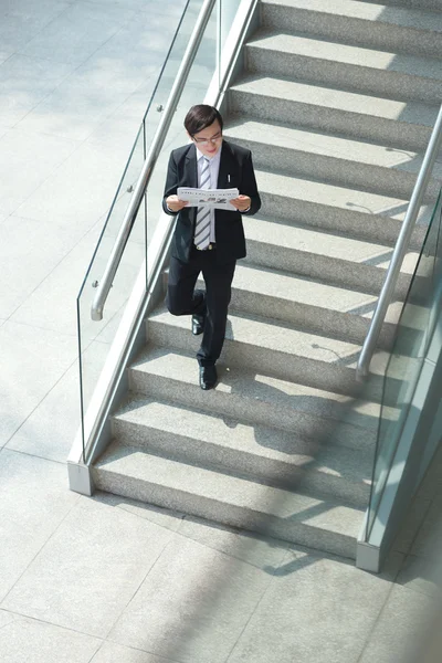 Businessman reading newspaper