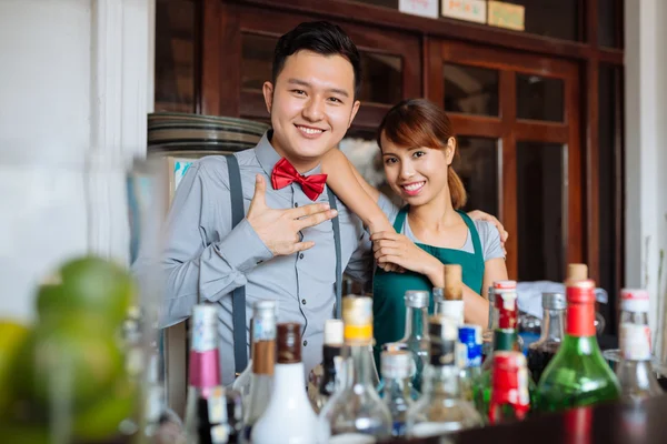 Cheerful barman and waitress
