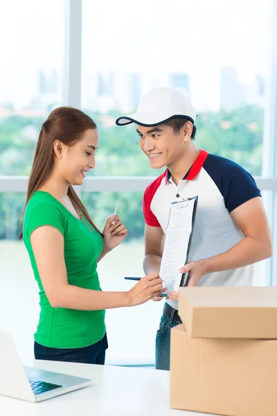 Woman signing for receiving packages