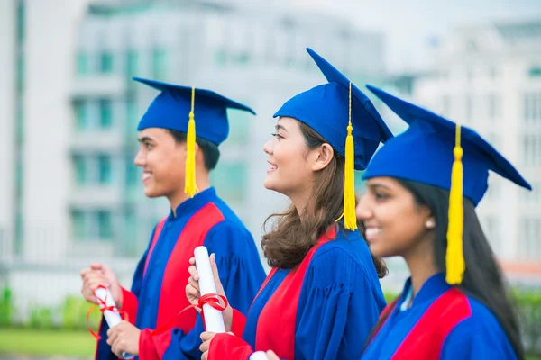 Graduated students standing in a row