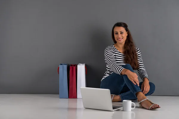 Lady  with laptop and shopping bags