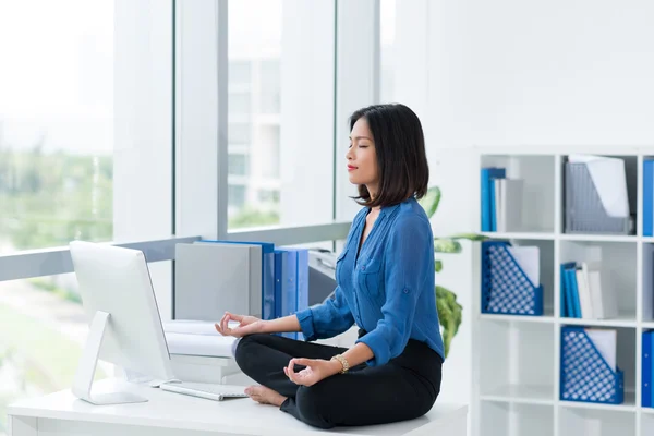 Office worker in lotus position