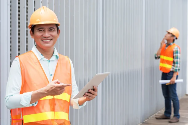 Asian contractor with a tablet