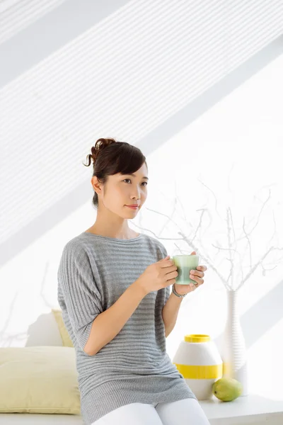 Lovely Japanese woman with cup of tea