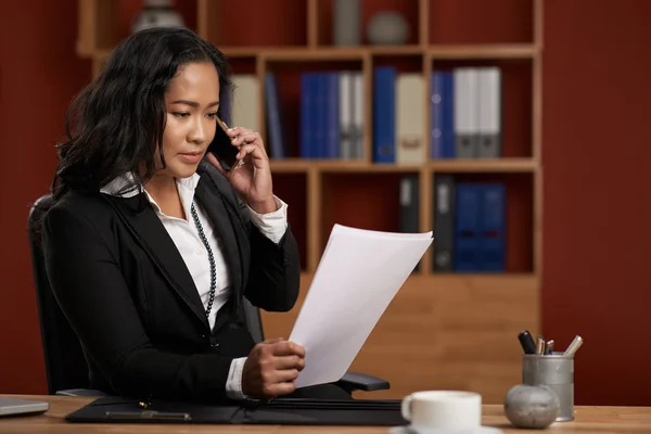 Female Asian lawyer reading contract