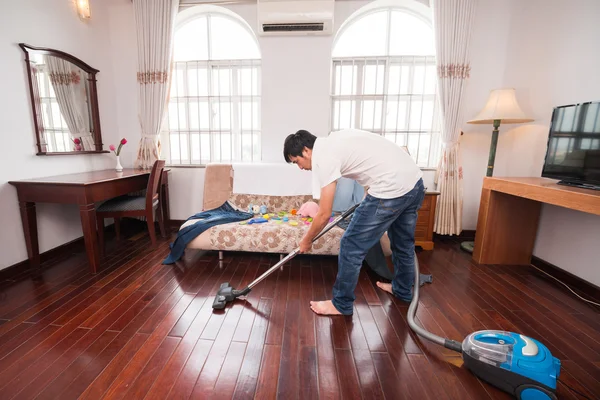 Househusband cleaning room