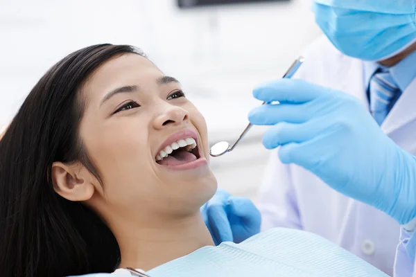 Dentist Using mouth mirror