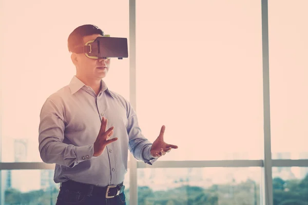 Businessman wearing virtual reality goggles