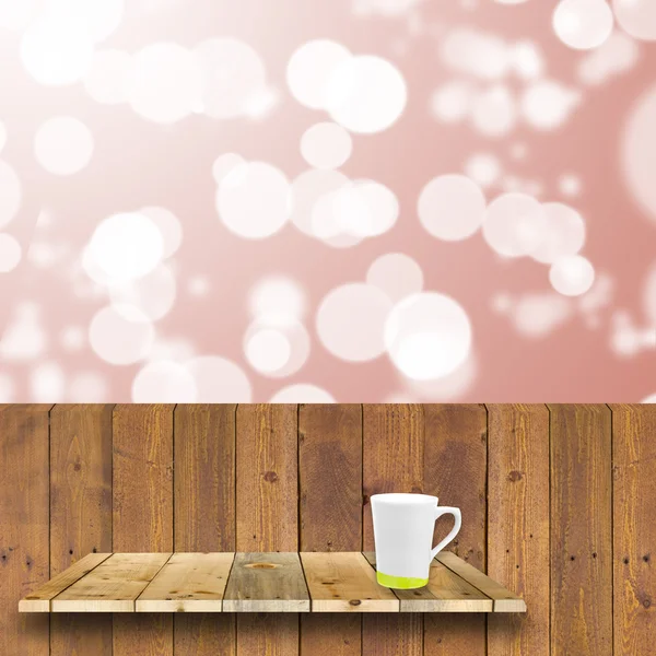 Wood shelve hang on wood plank wiht coffee cup in front of brigh