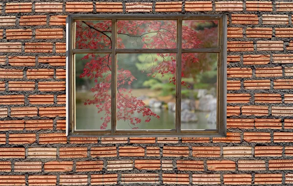 Autumn foliage color outside window with brick wall