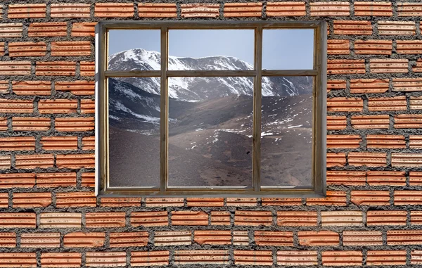 Snow mountain outside window with brick wall