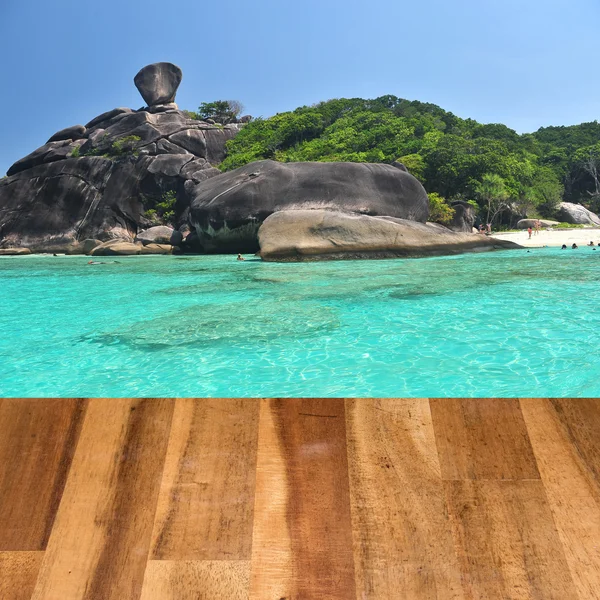Wood table top on seascape background montage concept