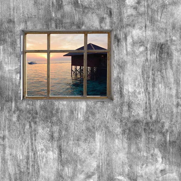 Windows frame on cement wall and view of tropical sea