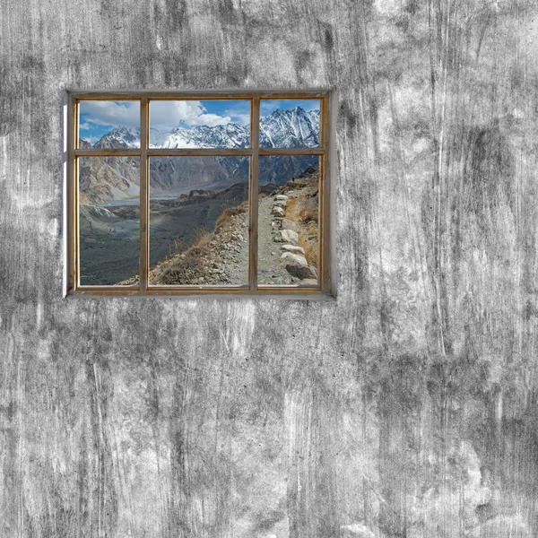 Windows frame on cement wall and view of Hunza valley, Pakistan