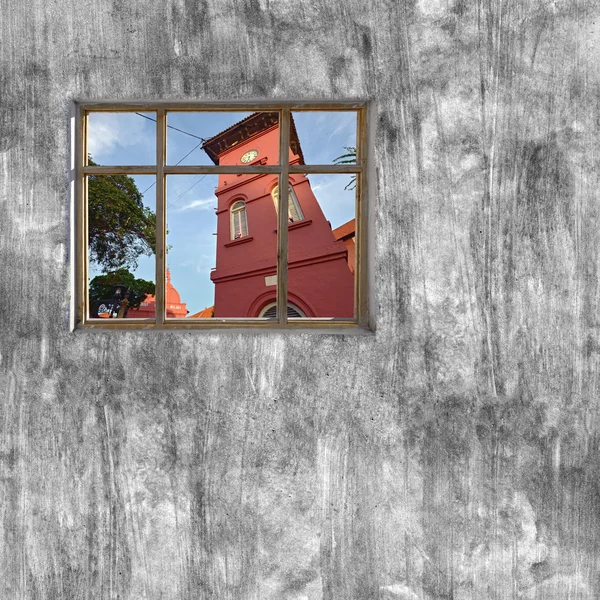 Windows frame on cement wall and view of Melaka, Malaysia