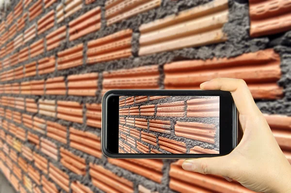 Brick wall. Taking photo on smart phone concept.
