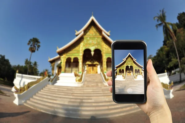 Lung Phra Bang, Laos. Taking photo on smart phone concept.
