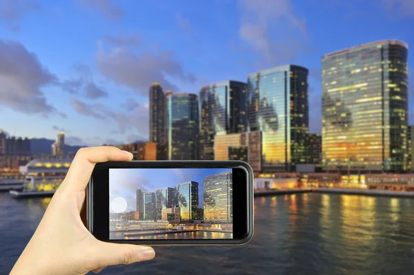 Cityscape of Hong Kong. Taking photo on smart phone concept.
