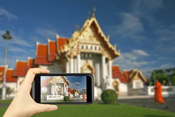Wat Benchamabophit in Bangkok, Thailand. Taking photo on smart p