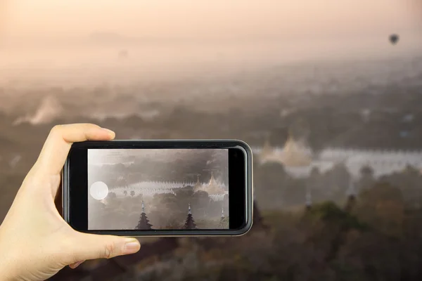 Mandalay hill in Myanmar. Taking photo on smart phone concept.